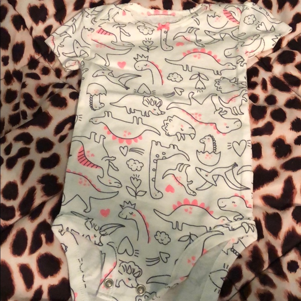 Pink and white dinosaur onesie